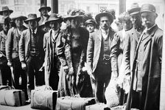 12-02 Photograph Of Immigrants Waiting With Their Bags Ellis Island Main Immigration Station Building.jpg